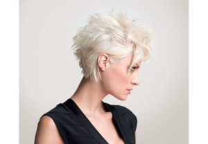 Model with pixie cut short and tousled in the back with long bangs