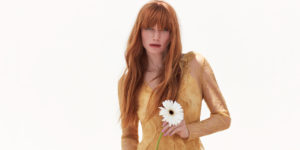Long red haired model holding a flower